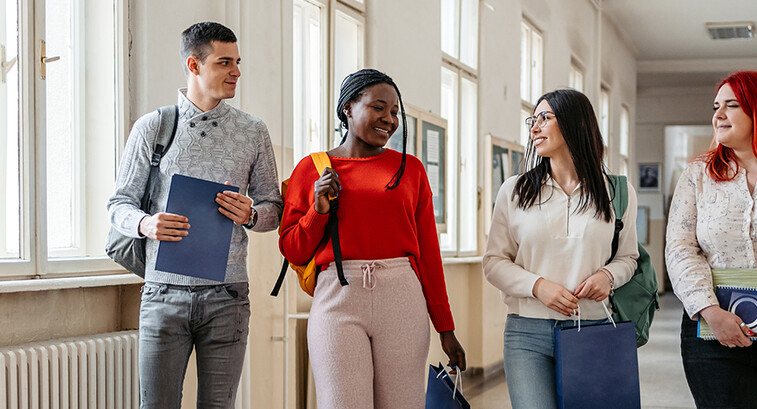 Students walking down the hall and talking.