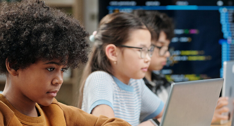 Students using laptops in school