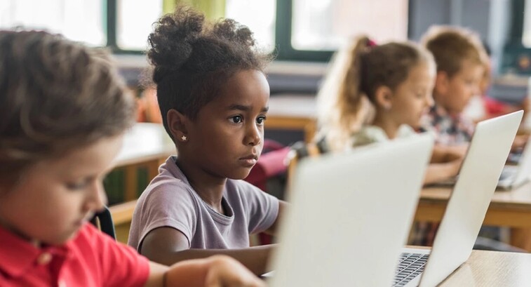 Young students working on laptops in school