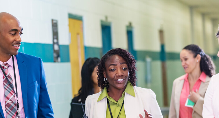 Diverse group of educators walking in hallway