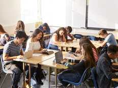 Students working at desks together in a classroom