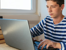 boy using laptop at home