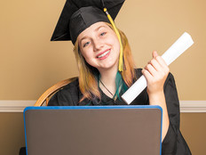 high school girl graduating on her laptop