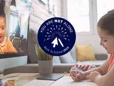 two young girls doing homework online together 