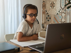 boy using laptop at home for learning