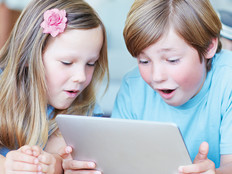 Two kids using a tablet for digital learning 