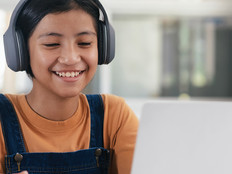 Student on laptop with headphones 