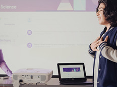 education articles 2022 Teacher and student using Chromebooks in classroom