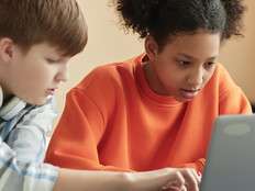 Students using laptop computer in school
