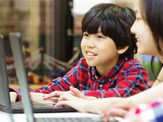 Students using laptops in school