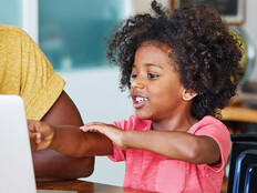 Parent using laptop with child