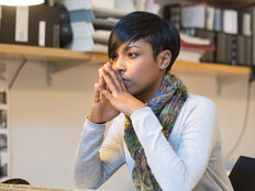 IT person mulling over information while sitting at desktop computer