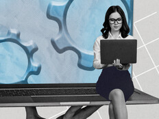 Person using laptop with gears in the background