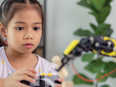 K12 student working on steam project with robot
