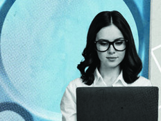 Person using laptop with gears in the background