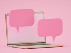 computer against pink backdrop with floating pink speech bubbles to indicate chatroom