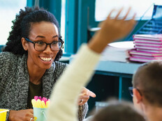 K12 teacher interacting with students in classroom