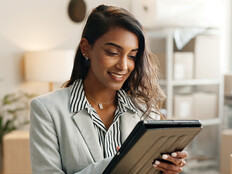 Person using tablet around boxes