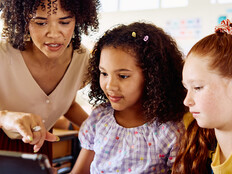 School teacher helping students
