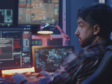 Security alerts appearing on multiple screens while man watches