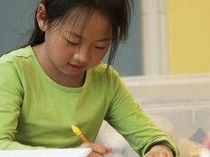A K-12 student focusing and working on a creative makerspace project