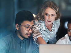 Coworkers using a laptop