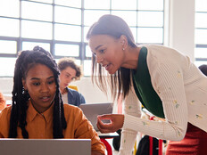 Teacher helping student in class