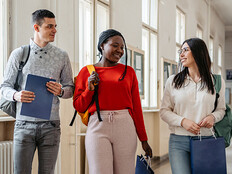Students walking down the hall and talking.