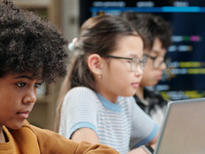 Students using laptops in school