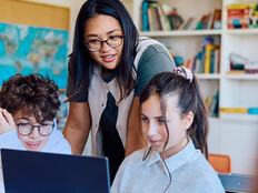Students using computer in classroom