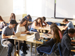 Students working at desks together in a classroom