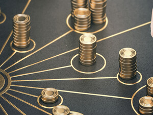 Chess piece surrounded by stacks of gold coins