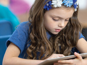 Student using tablet in class