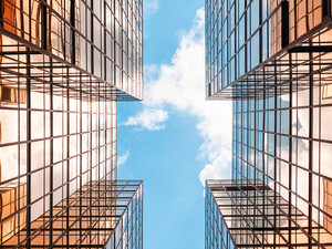 Digital twins concept showing the sky between two glass buildings