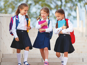 Elementary students walking on school campus