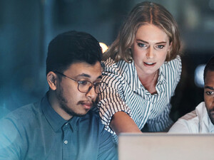 Coworkers using a laptop
