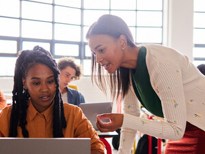Teacher helping student in class