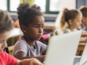 Young students working on laptops in school