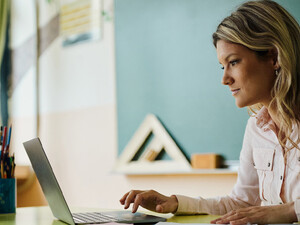 Teacher using laptop