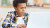 boy doing remote learning 