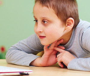 Young boy with special needs using laptop