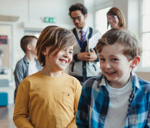 students and teachers walking through school hallways