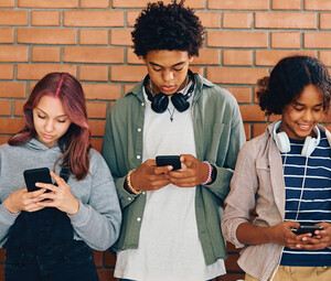 Students looking at phones in school