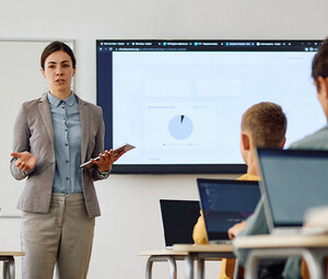 Teacher instructing class with technology