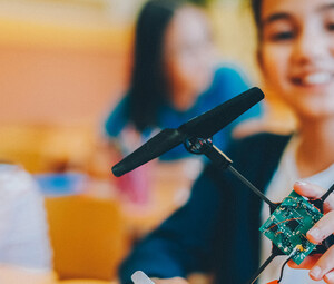 Students assembling a drone