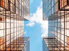 Digital twins concept showing the sky between two glass buildings